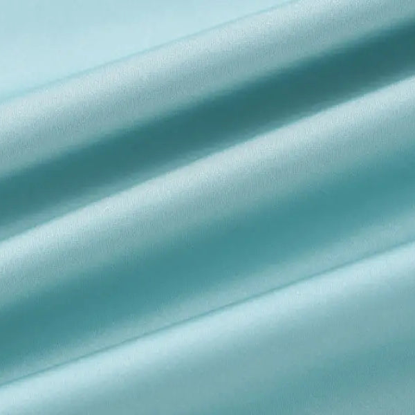 Diagonal turquoise and teal blurred stripes in a satin halter backless dress design