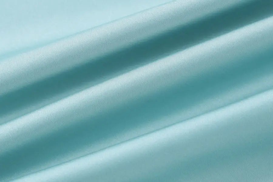 Diagonal turquoise and teal blurred stripes in a satin halter backless dress design