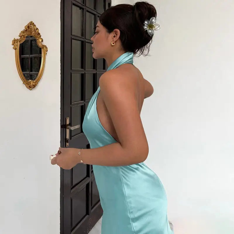 Elegant turquoise satin halter backless dress featuring a fitted silhouette and bodycon style