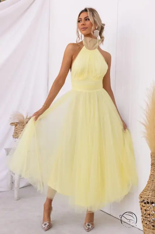 Woman in yellow elegant halter evening dress for summer occasions