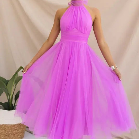 Woman in a vibrant purple elegant halter evening dress for summer occasions