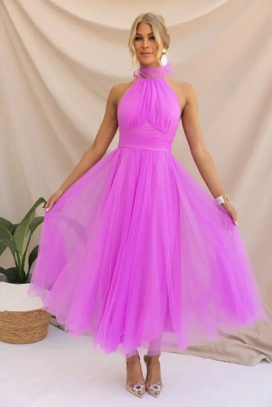 Woman in a vibrant purple elegant halter evening dress for summer occasions