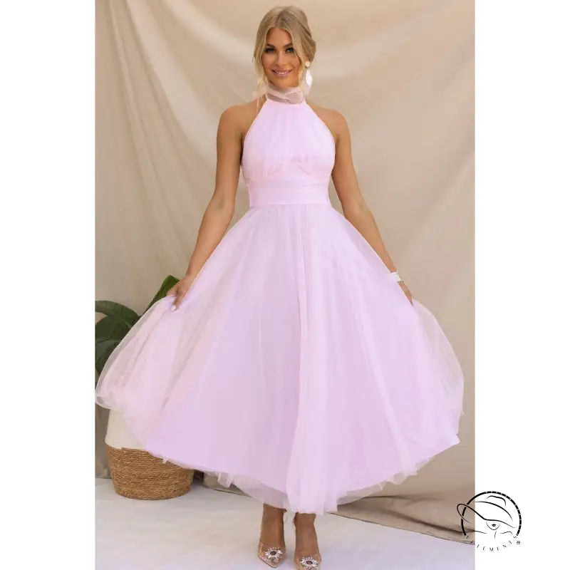 Woman in elegant halter evening dress in pink mesh and lace
