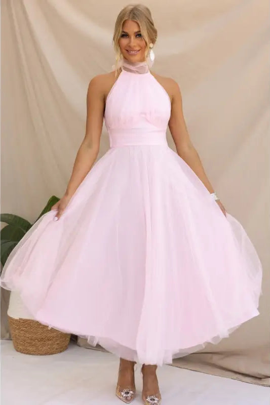 Pink halter-neck tulle dress showcasing an elegant halter evening design for summer occasions