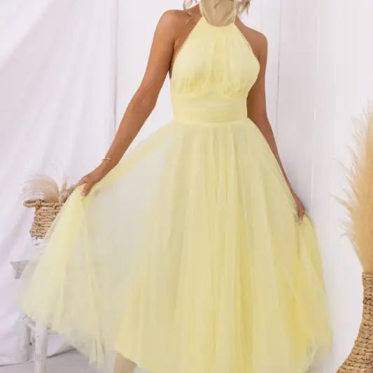 Yellow halter-neck tulle dress as an elegant halter evening dress for summer occasions