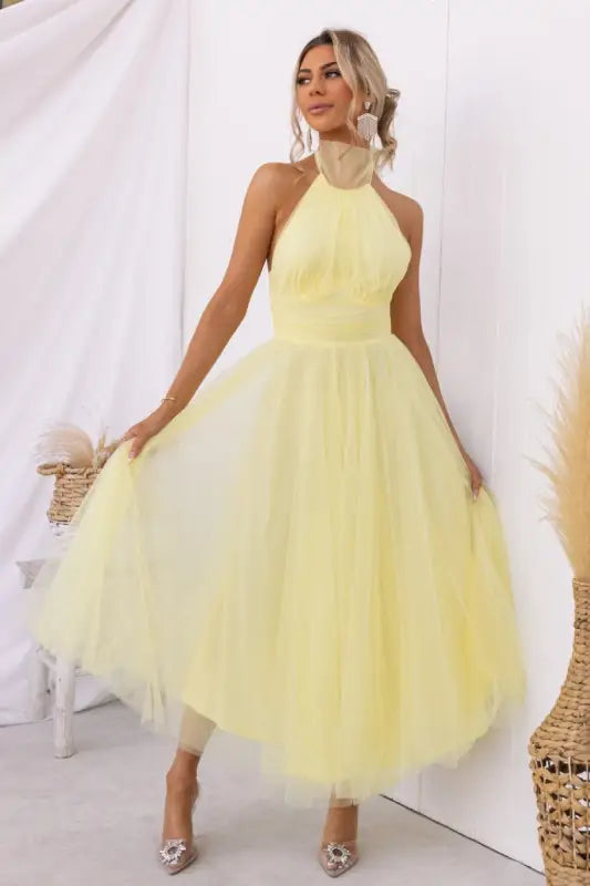Yellow halter-neck tulle dress as an elegant halter evening dress for summer occasions