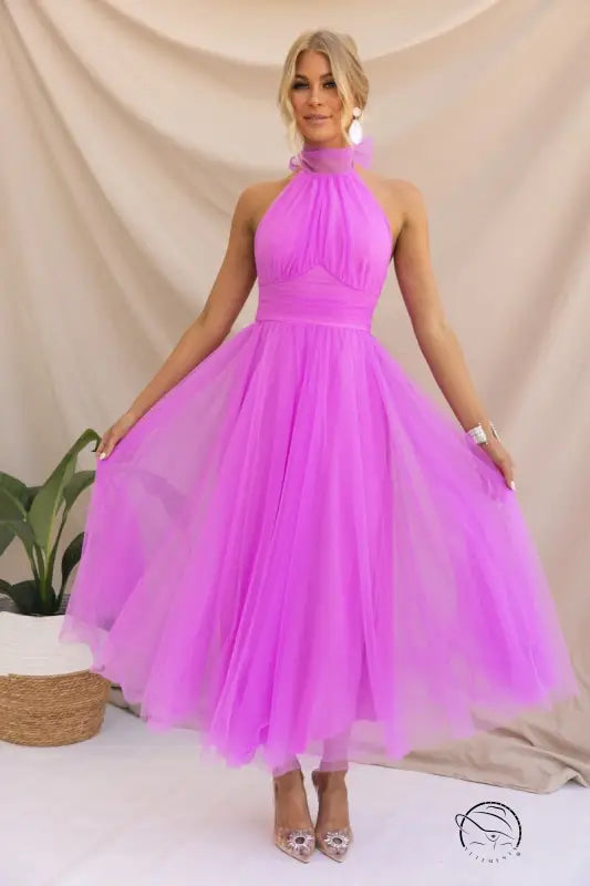 Elegant halter evening dress: woman in bright pink tulle for summer occasions