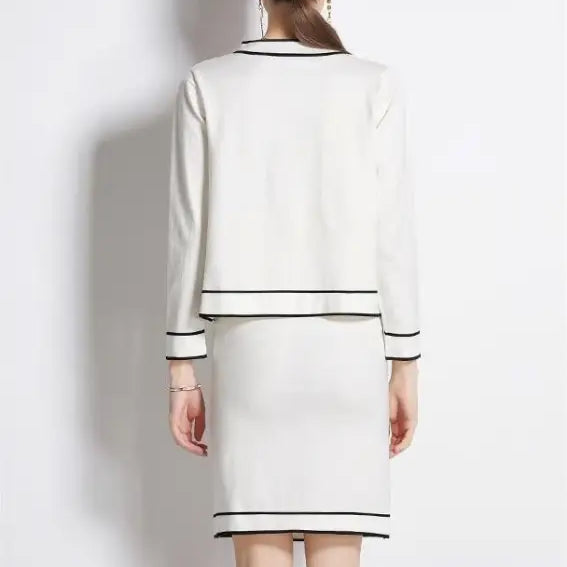 White two-piece high rise long sleeve skirt set with black trim for spring and fall outfits