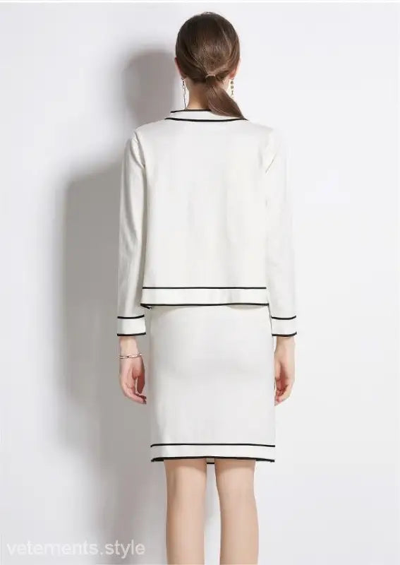 White two-piece high rise long sleeve skirt set with black trim for spring and fall outfits
