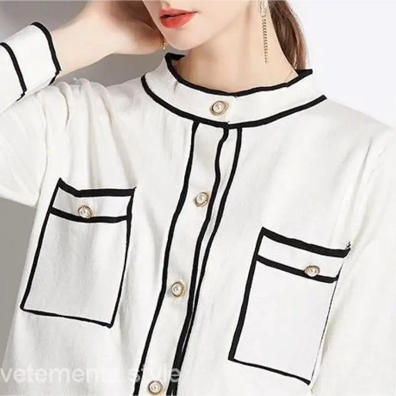 Elegant high rise long sleeve blouse with black trim and decorative buttons for long sleeve skirt sets