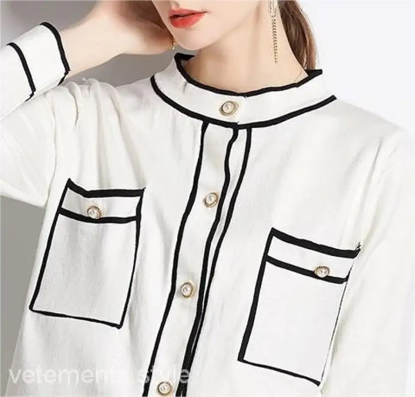 Elegant high rise long sleeve blouse with black trim and decorative buttons for long sleeve skirt sets