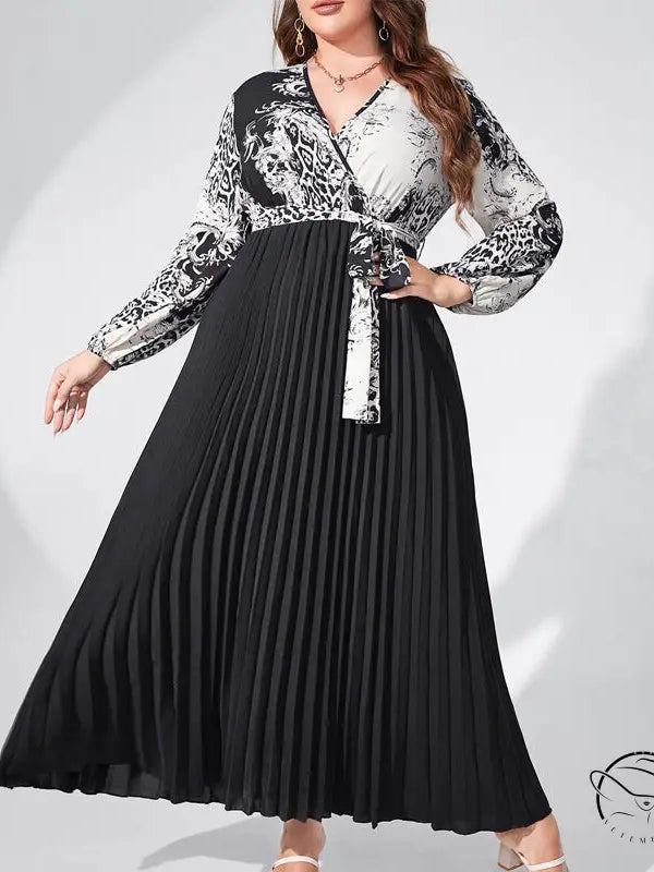 Elegant high waist maxi dress with belted V-neck, lantern sleeves, black pleated skirt, and white-black patterned bodice
