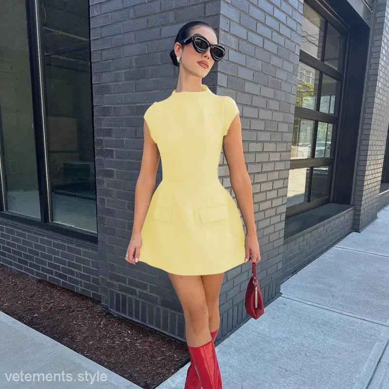 Woman in a yellow dress and red boots showcasing a sexy high waist short dress