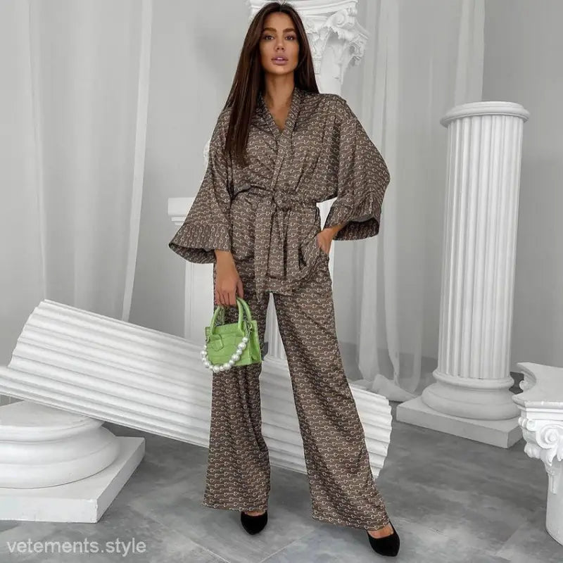 Woman in patterned ice silk pajama set with green purse, featuring nightgown pajama pants