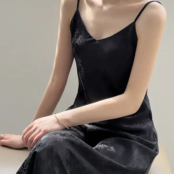 Elegant jacquard v-neck strap dress featuring a black spaghetti-strap design with subtle floral pattern