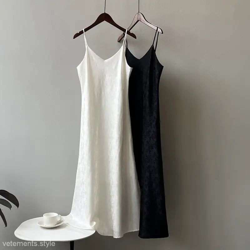 Elegant jacquard V-neck strap dresses in black and white hanging on wooden hangers