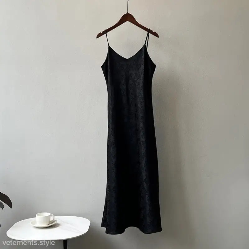 Elegant jacquard V-neck strap dress hanging on a wooden hanger for summer wear