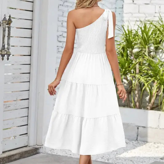White one-shoulder pleated layered slit dress with tiered design for elegant occasions