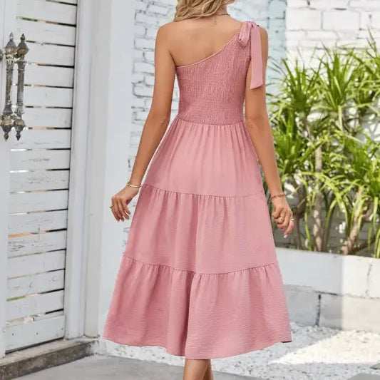 Pink one-shoulder pleated layered slit dress showcasing elegant design and fashion style