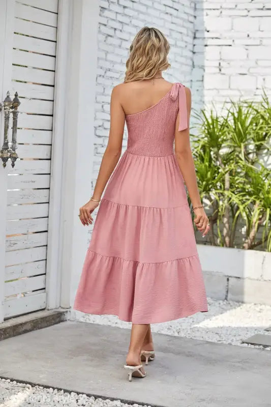 Pink one-shoulder pleated layered slit dress showcasing elegant design and fashion style