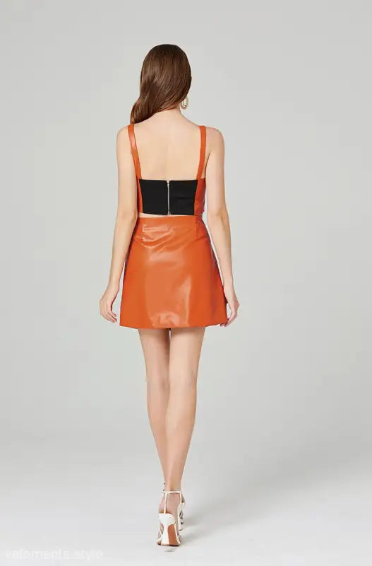 Orange faux leather two-piece set with zipper V-neck top and hip skirt for summer