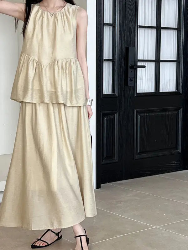 Beige two-piece dress featuring lightweight loose Tencel tiered top and cutout design