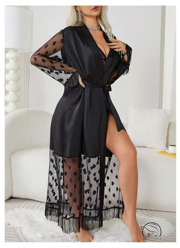 Black sheer robe with polka dot pattern and fringe trim.