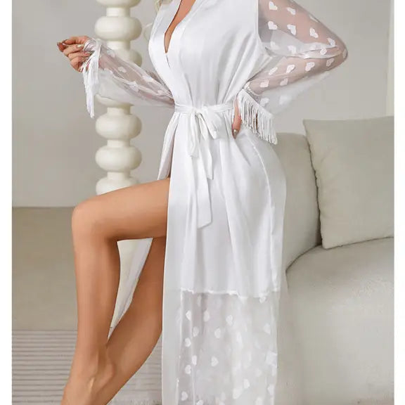 White sheer robe with polka dot sleeves, fringe trim, and a waist tie.