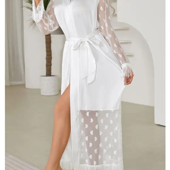 White lace robe with sheer sleeves, a high slit, and fringe details.