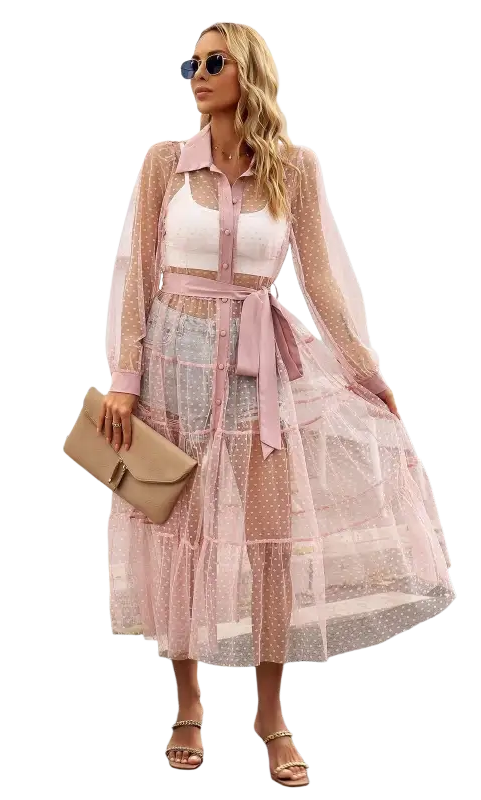 Woman in a sheer pink polka dot summer mesh dress showcasing a long sleeve waist dress design