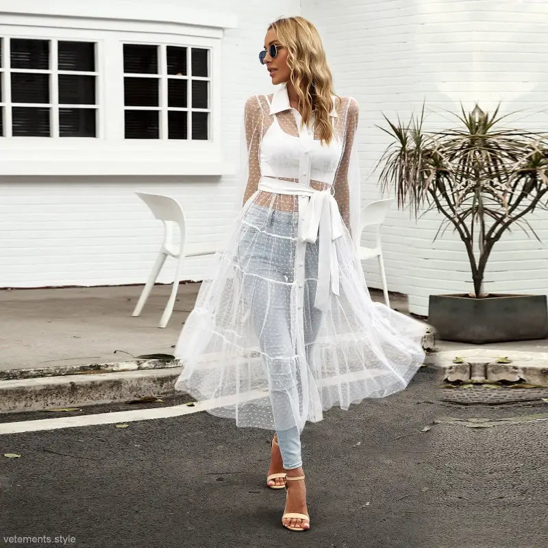 Woman in sheer white polka dot summer mesh dress, long sleeve waist dress for summer style