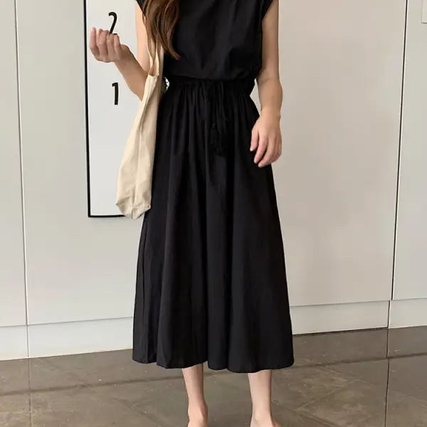Black sleeveless midi dress with a gathered waist and flowing skirt.