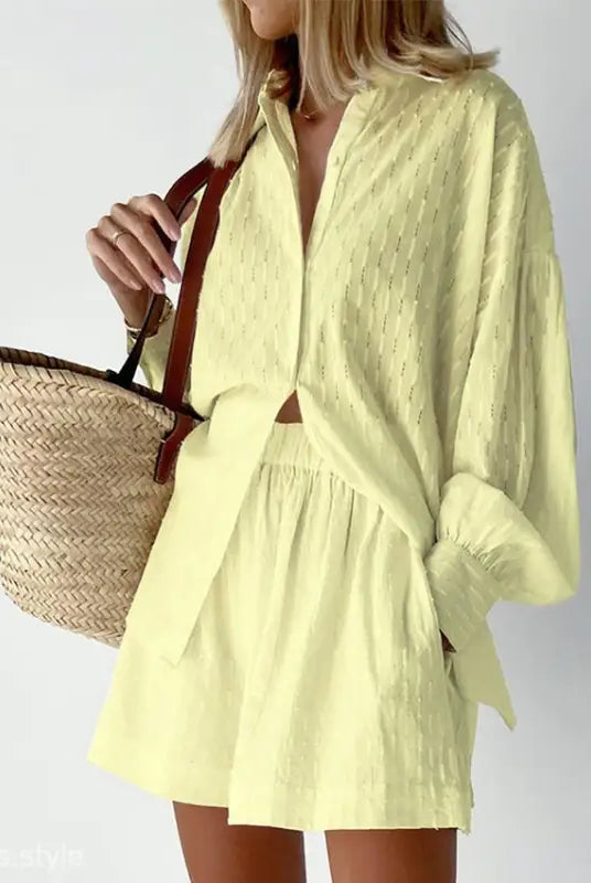 Yellow two-piece shorts office suit with elegant design and straw tote bag