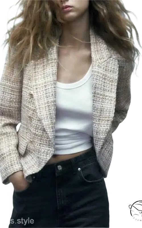 Textured beige loose houndstooth blazer styled over a white tank top and dark jeans