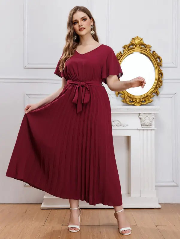 Elegant loose pleated maxi dress with V-neckline and tie-waist for sophisticated style