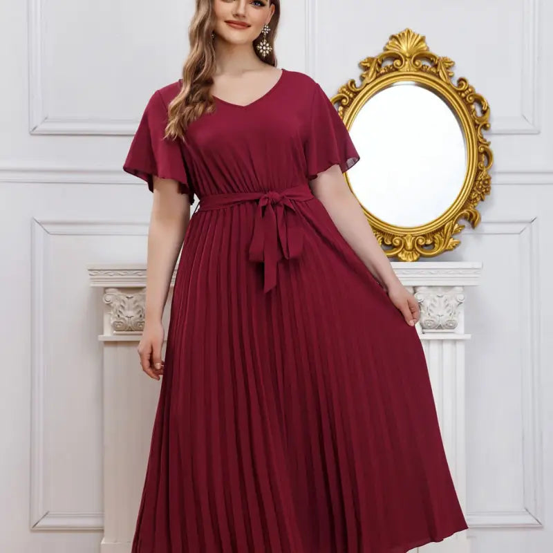 Elegant loose pleated maxi dress in deep burgundy with short flared sleeves and tie waist