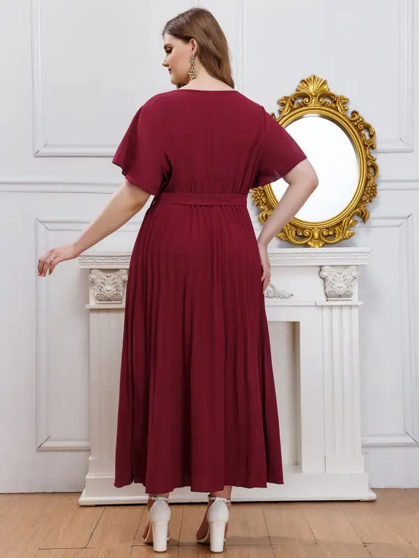 Elegant loose pleated maxi dress for women with V-neck, flutter sleeves, and belted waist