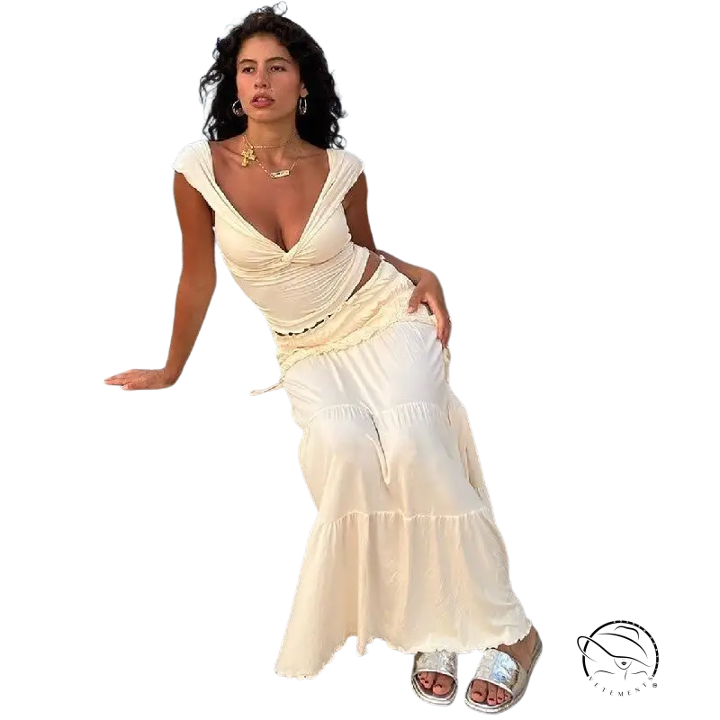 Woman in sexy French outdoor low cut short set on rocky coastal ledge