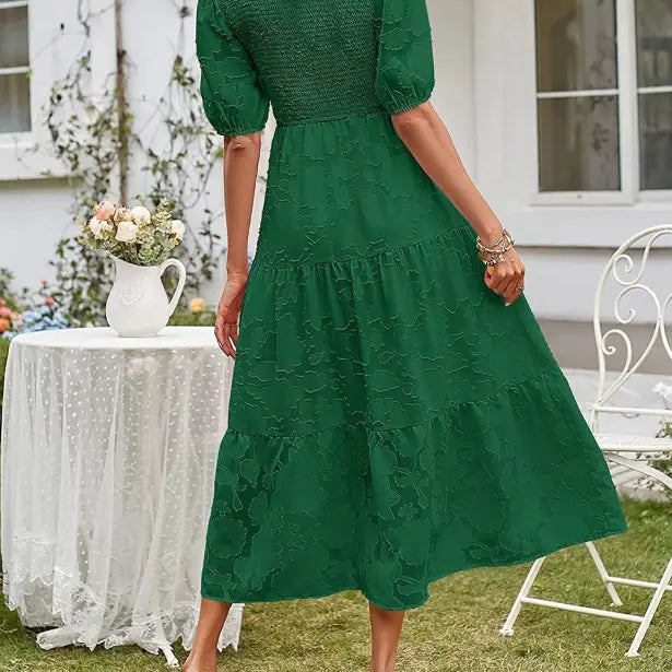 Green tiered midi dress featuring pleated puff sleeves and chic cutout detail