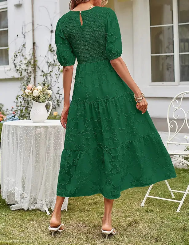 Green tiered midi dress featuring pleated puff sleeves and chic cutout detail
