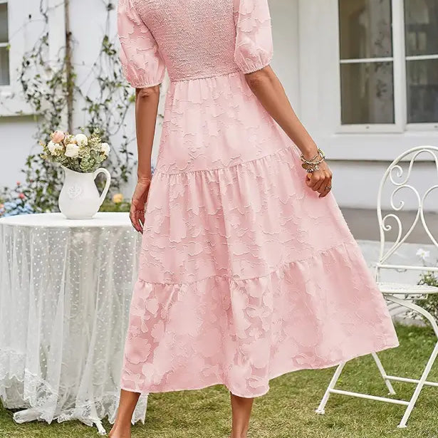 Pink textured midi dress featuring elegant pleated puff sleeve and cutout detail