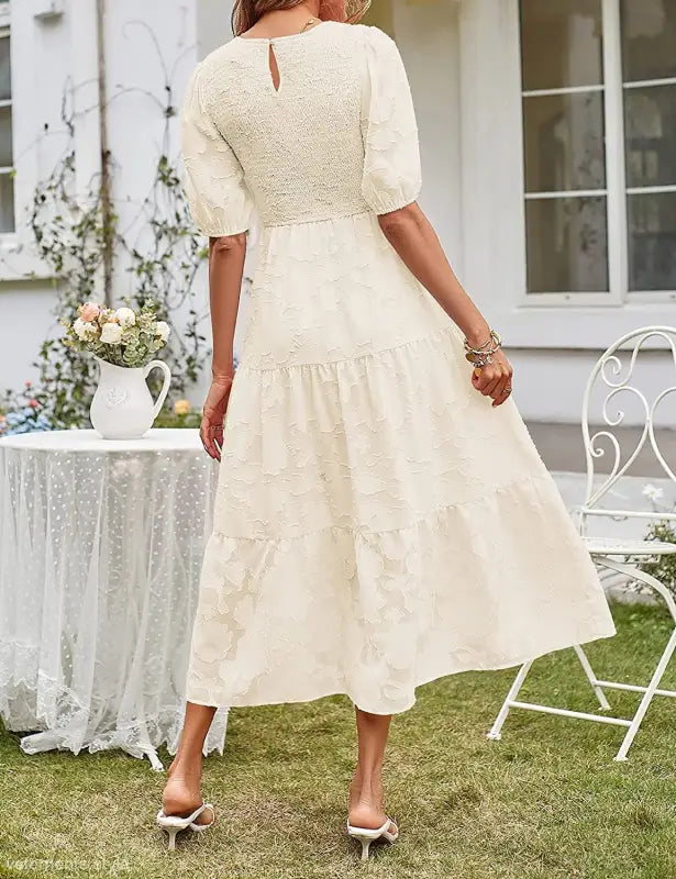Cream-colored textured midi dress featuring pleated puff sleeve and cutout detail