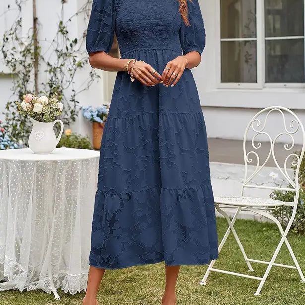 Navy blue tiered midi dress featuring pleated puff sleeves and cutout detail