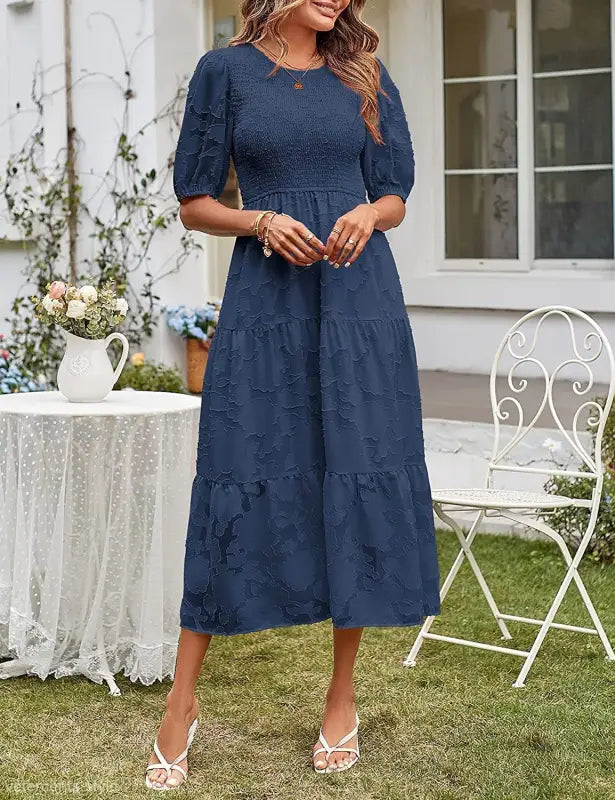 Navy blue tiered midi dress featuring pleated puff sleeves and cutout detail