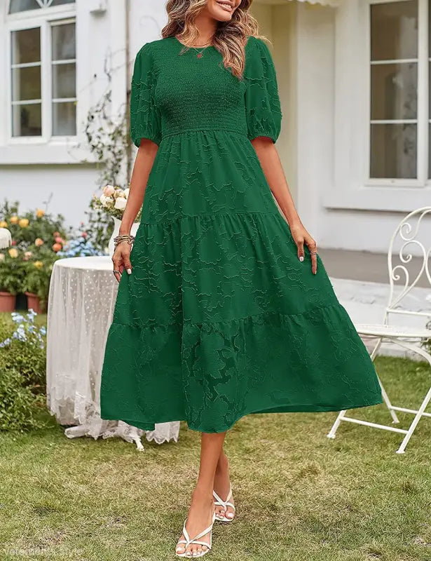 Emerald green midi dress featuring elegant pleated puff sleeve and stylish cutout detail