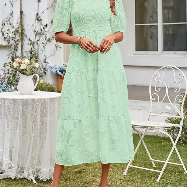 Mint green tiered midi dress featuring pleated puff sleeve and elegant cutout detail