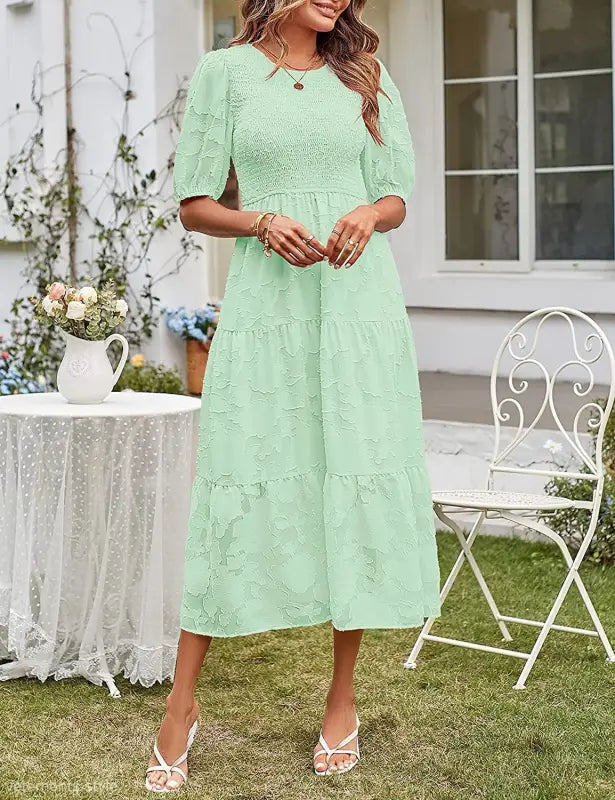 Mint green tiered midi dress featuring pleated puff sleeve and elegant cutout detail