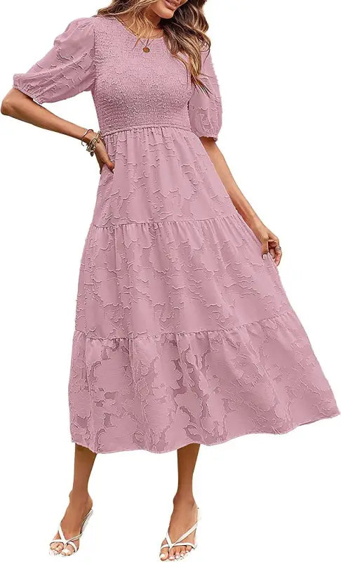 Pink tiered midi dress featuring pleated puff sleeves and elegant cutout detail