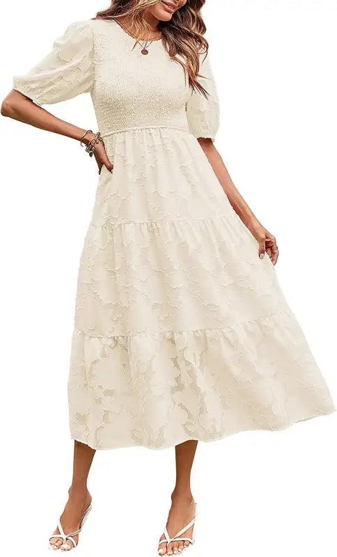 Cream-colored tiered midi dress featuring elegant pleated puff sleeve and cutout detail