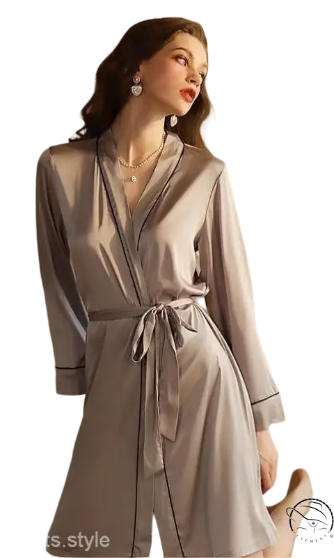 Woman in elegant gray midi silk pajamas with belted sleeves and tie waist